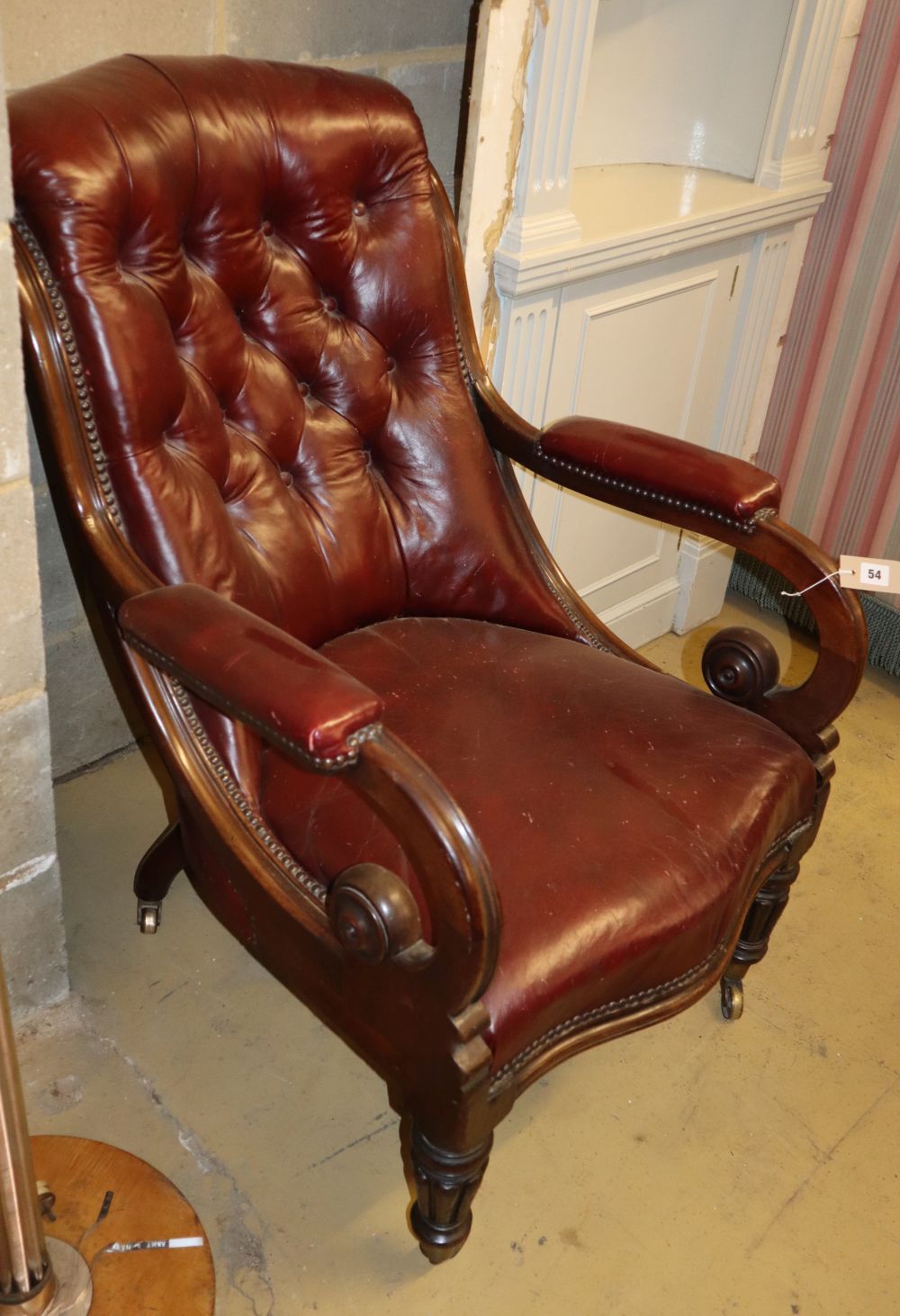 A Victorian mahogany ox blood leather open armchair